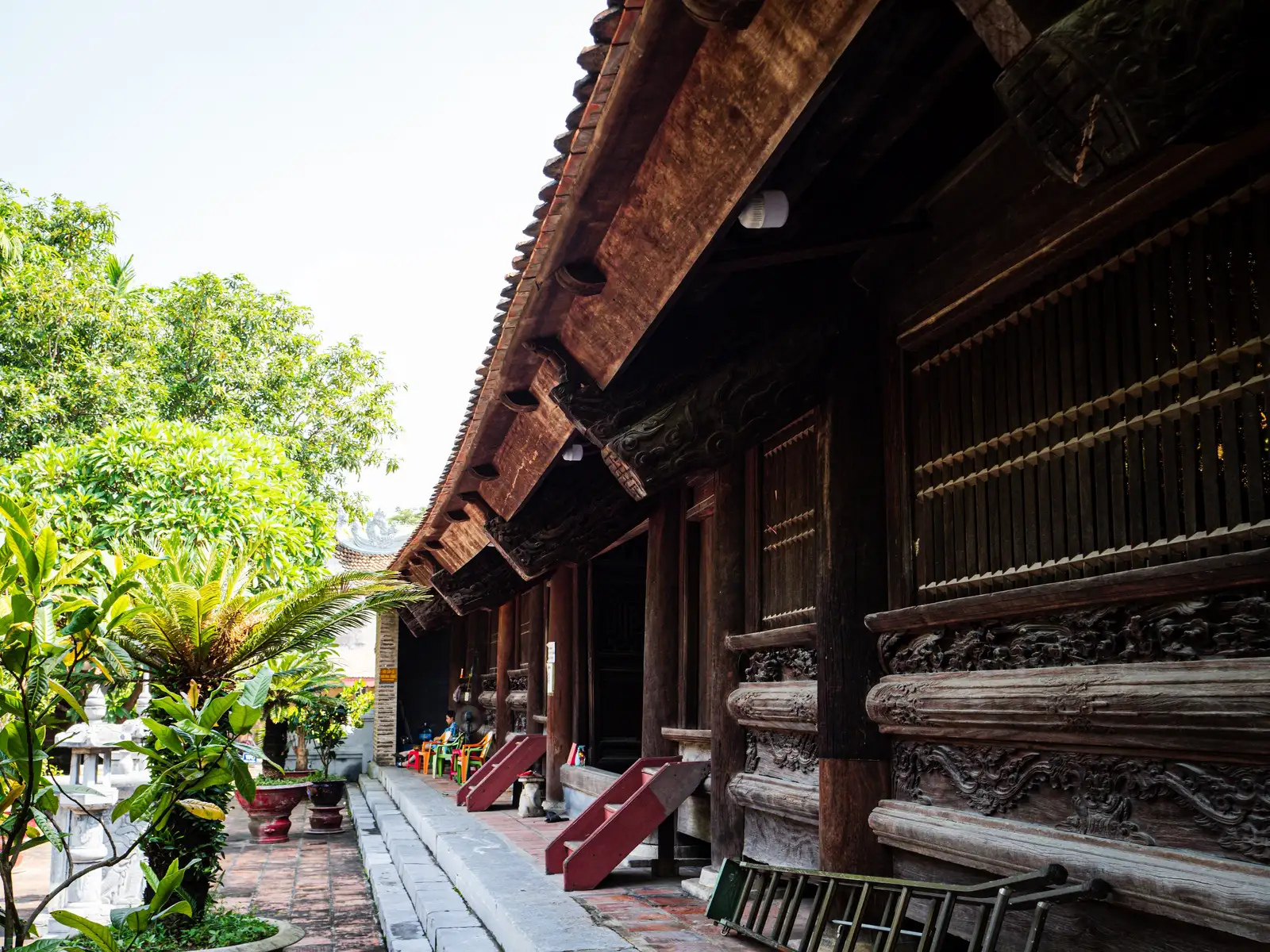 Carved wooden panels and columns line a hall at Hang Kenh Communal House.